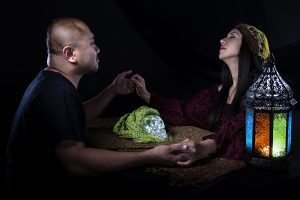 Psychic or fortune teller gypsy with a client doing a seance telepathic ritual