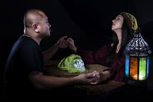 Psychic or fortune teller gypsy with a client doing a seance telepathic ritual