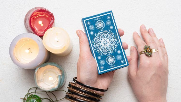 hand holding a deck of tarot cards